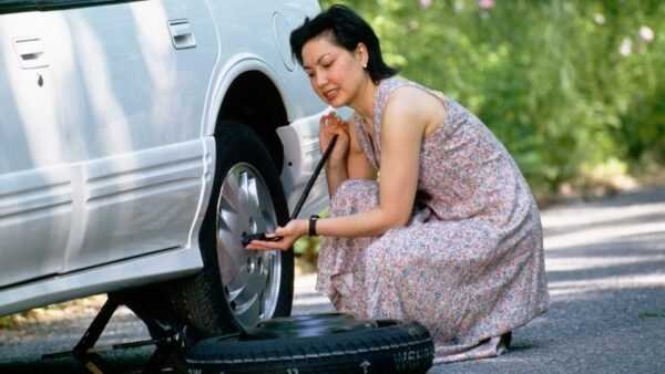 woman changing tire
